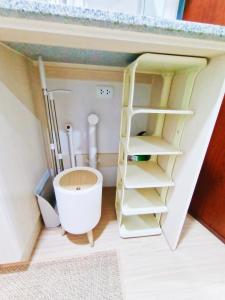 a small bathroom with a toilet and a bath tub at The Hive tower D with pool, Wifi, and balcony in Taytay