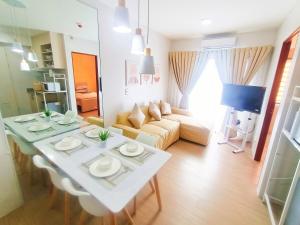 a living room with a table and a couch at The Hive tower D with pool, Wifi, and balcony in Taytay