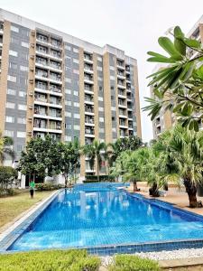an empty swimming pool in front of buildings at The Hive tower D with pool, Wifi, and balcony in Taytay