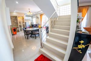 a staircase in a home with a table and a dining room at Happy House Betong in Betong