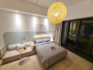 a bedroom with a large bed and a chandelier at M city service suite KLCC in Kuala Lumpur