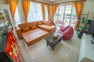 a living room with a couch and a table at Happy House Betong in Betong