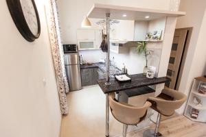 a kitchen with a table and chairs in a room at Apartment Diana in Košice