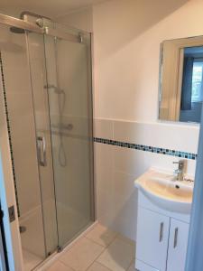 a bathroom with a shower and a sink at The Old Rope Works in Woburn Sands +23 photos