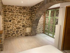 a room with a stone wall and a window at Appartement centre ville en RDC in Lorgues