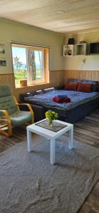 a bedroom with a bed and a table and a couch at Trammi Maja in Rannaküla