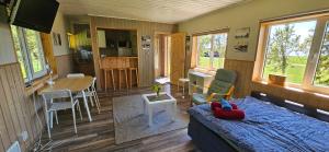 a room with a bed and a kitchen with a table at Trammi Maja in Rannaküla
