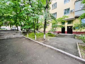 an empty parking lot in front of a building at Однушка в центре Алматы, до Арбата 5 минут ходьбы #82 in Almaty
