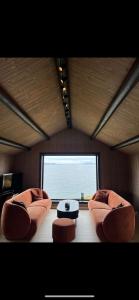 a living room with two couches and a large window at Jacuzzi, utekjøkken og sjøutsikt i hel hytte ved sjøen in Hitra