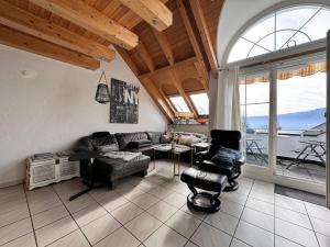 a living room with a couch and a table and chairs at Casa Via Bodman-Ludwigshafen in Bodman-Ludwigshafen