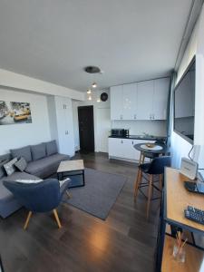 a living room with a couch and a table at Klaipėda city panoramic view in Klaipėda +9 photos