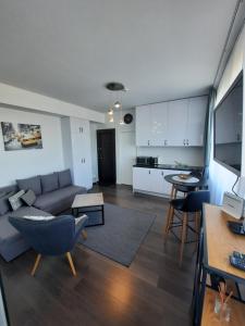 a living room with a couch and a table at Klaipėda city panoramic view in Klaipėda