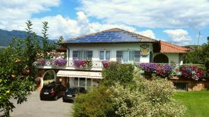 a house with a lot of solar panels on the roof at Agritur Casamela in Taio +58 photos