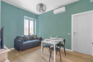 a blue living room with a table and a couch at SIL5 - Apartment Bright - Luxury in Milan