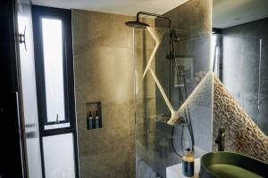 a bathroom with a shower with a green tub at Solitude Tahura Villa Bandung in Cicadas +24 photos