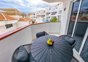 a table with bananas and fruit on it on a balcony at Gorgeous Los Diamantes Home in Los Cristianos