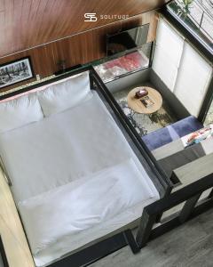 an empty bed in an rv with a table at Solitude Tahura Villa Bandung in Cicadas