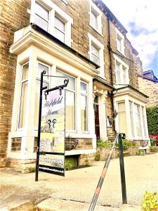 a sign in the street in front of a building at Highfield Guesthouse in Skipton +35 photos