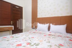 Letto o letti in una camera di Tatti Inn Syariah Seturan RedPartner