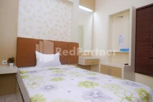 Letto o letti in una camera di Tatti Inn Syariah Seturan RedPartner