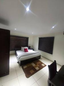 a bedroom with a bed and a couch and a chair at TRENDY INN HOTEL in Lagos