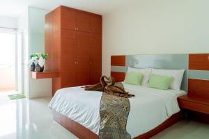 una camera da letto con un letto grande con testiera in legno di The Infinity Suite Chiangrai a Chiang Rai