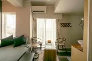 a living room with a couch and a sink at Hotel SERA LUNA -ホテル セラルナ- in Naha +25 photos