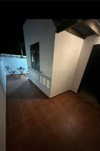 a room with a white wall and a tile floor at Casa Emma in Playa Honda