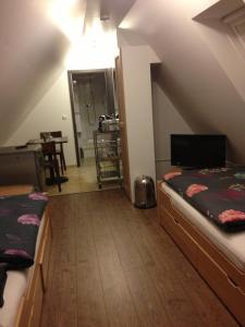 a attic room with two beds and a mirror at Old Town Guesthouse Erlangen in Erlangen