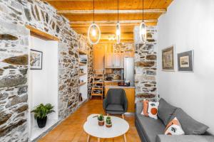 a living room with a couch and a table at La Bella Pietra in Ermoupoli