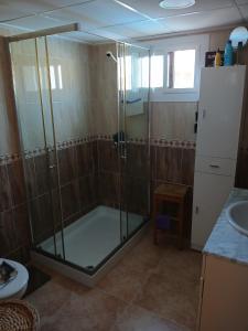 a shower with a glass door in a bathroom at Casa Antonio in Águilas