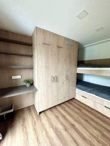 a room with wooden floors and bunk beds at Vika Minihouse in Kristiansund