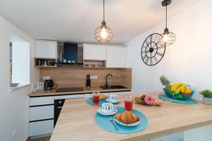 a kitchen with a wooden table with food on it at Apartmans and studios Ana in Trogir