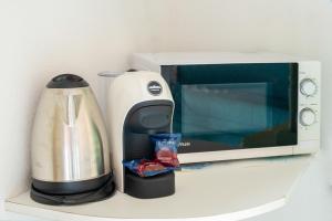 a coffee maker and a microwave on a counter at VILLA MARIA - CAPO D'ORSO - HOME and MORE in Palau