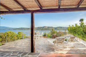 a view of the water from the porch of a house at VILLA MARIA - CAPO D'ORSO - HOME and MORE in Palau