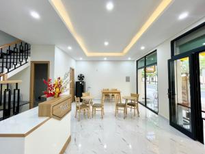 a dining room with a table and chairs at Teddy 96 Homestay & Cafe-3 stars-Grand World Phu Quoc in Phu Quoc