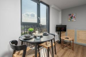a dining room with a table and a large window at Chavasse Apartments, 1 Bed Studio, Parking - Pass the Keys in Liverpool