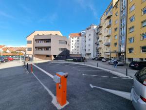 an empty parking lot in a parking lot with buildings at Oldie goldie in Maribor