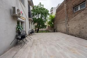 an empty courtyard with chairs and a building at Comanda LUXURY APARTMENTS in Belgrade