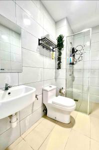 a white bathroom with a toilet and a sink at Melaka AmberCove Homely Seaview 2R2B in Malacca
