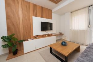 a living room with a tv on a wall at Comanda LUXURY APARTMENTS in Belgrade