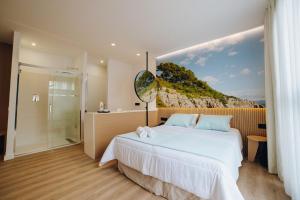 a bedroom with a large bed and a shower at Alannia Salou in Salou