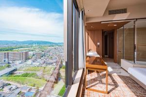 a balcony with a view of a city at Candeo Hotels Osaka Hirakata in Hirakata
