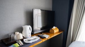 a television sitting on a shelf in a room at Hotel SERA LUNA -ホテル セラルナ- in Naha