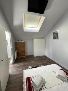a attic bedroom with two beds and a skylight at Apartment 6 confort&modern in Arad