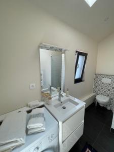 a bathroom with a sink and a toilet and a mirror at Apartment 6 confort&modern in Arad +25 photos
