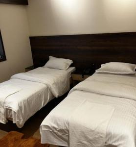 Llit o llits en una habitació de ANT Biz Rooms Near Chennai Trade Centre