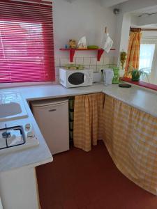 a kitchen with a counter with a microwave on it at Studio meublé in Antigny-la-Ville