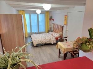 a small room with a bed and a table and a table sidx sidx at Studio meublé in Antigny-la-Ville