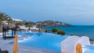 a large swimming pool with a view of the ocean at Saint John Hotel Villas & Spa in Agios Ioannis Mykonos